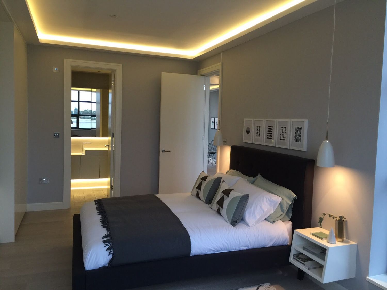 Bedroom with cove lighting and fitted joinery